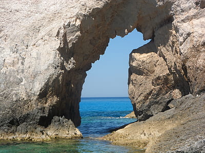 grey monolith rock on body of water thumbnail