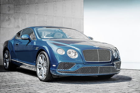 blue car parked near wall thumbnail