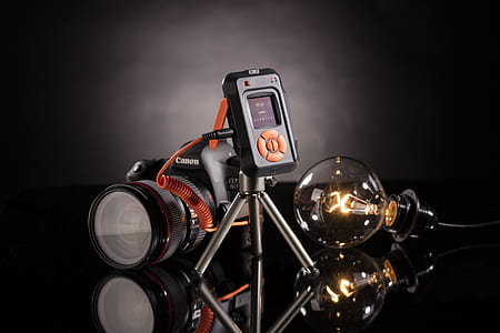 Canon DSLR camera beside light bulb thumbnail