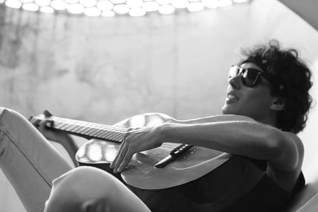 Grayscale Photo of Man Playing Guitar thumbnail