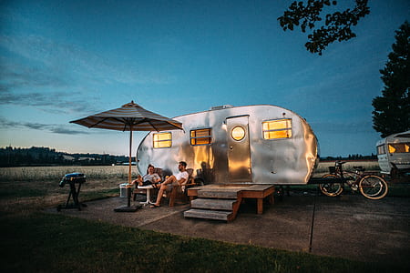 man sitting near travel trailer thumbnail