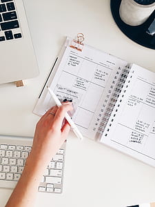 person holding pen on notebook thumbnail
