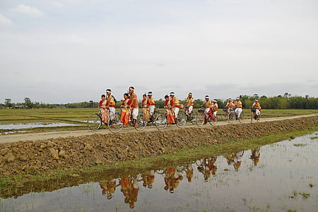people riding bike near body of water thumbnail