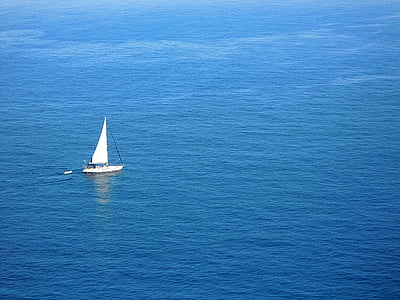 white sail boat on body of water during daytime thumbnail