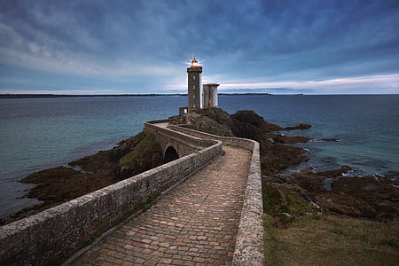 photo of gray concrete lighthouse during nighttime thumbnail