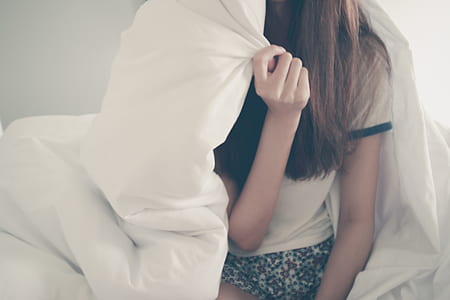 woman in white shirt holding comforter thumbnail