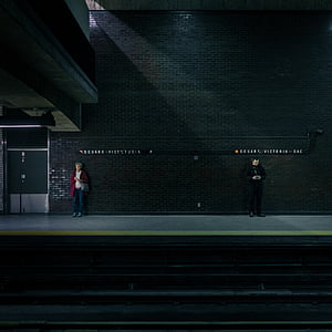two man and woman standing in-front of black building thumbnail