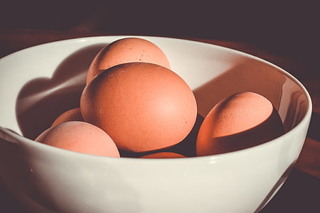 close-up photo of brown eggs in white ceramic bowl thumbnail