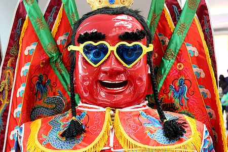 red ceramic figurine of man thumbnail