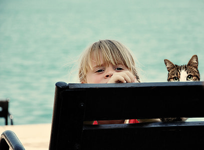 girl sitting next to cat thumbnail