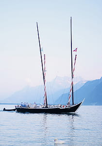 Photo of Black Sail Boat on Water thumbnail