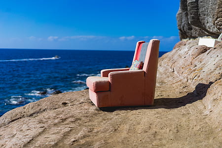 orange fabric sofa chair on cliff thumbnail