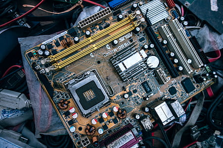 close up photography of brown and multicolored computer motherboard thumbnail