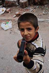 boy holding pistol toy thumbnail