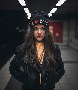 selective focus photography of woman standing on subway thumbnail