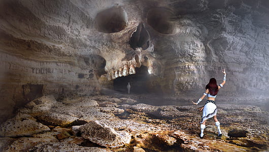 woman wearing white dress in front of skull cave illustration thumbnail