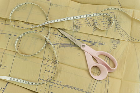 white scissors beside white tape measure thumbnail
