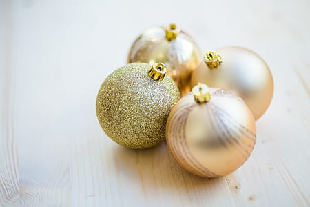 selective focus photography of four baubles on beige wood thumbnail