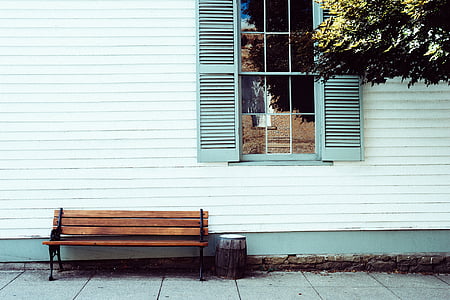 brown wooden bench behind wall thumbnail
