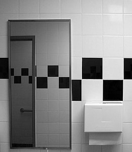 rectangular gray metal framed mirror on wall in bathroom thumbnail