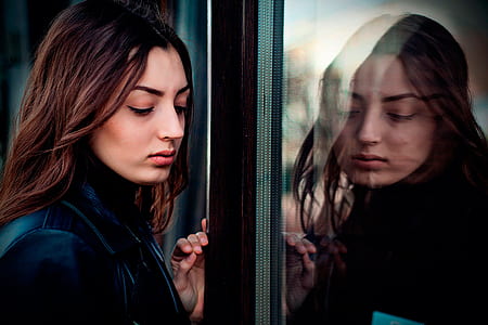 woman standing in front of reflection on glass door thumbnail