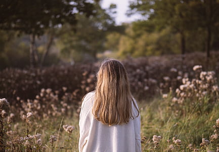 woman fronting bed of flowers thumbnail