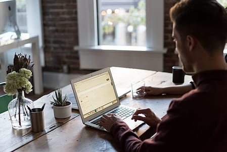 man wearing maroon dress shirt using MacBook Air thumbnail