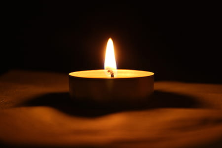 tealight candle on brown surface thumbnail