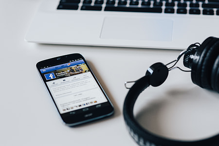 White laptop with smartphone and headphones thumbnail