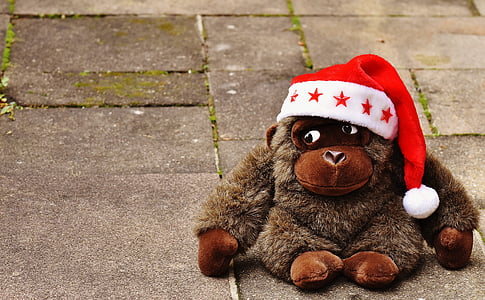 brown monkey plush toy wearing Santa hat thumbnail