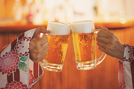 two person holding and cheers beer mugs thumbnail