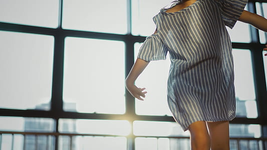 woman standing beside black framed glass wall thumbnail