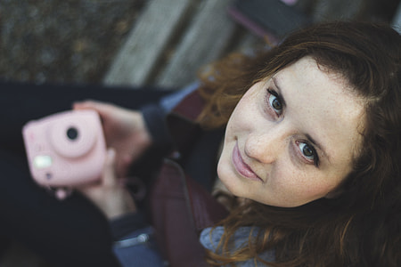 woman holding Instax camera thumbnail