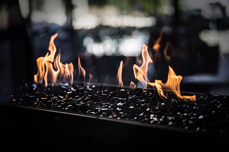 close-up photography of black charcoal with flame at daytime thumbnail