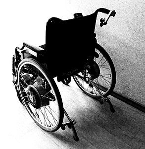 black wheelchair near gray concrete wall thumbnail