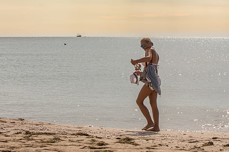woman standing beside seashore during daytime thumbnail