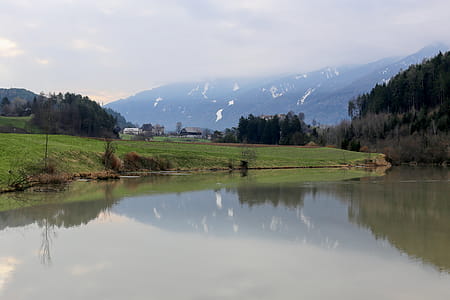 Landscape Photography of Green Grass Field Near River thumbnail