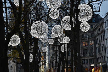 white pendant lamps attached on brown wooden trees thumbnail