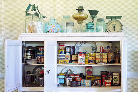 kitchen weighing scale and glassware on top of white wooden cabinet opened with rations thumbnail
