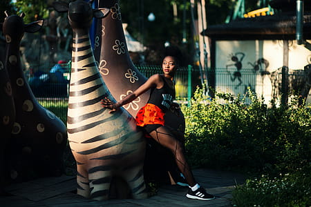 Photo of Woman Beside Zebra Statue thumbnail