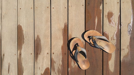 pair of brown flip flops on dock thumbnail