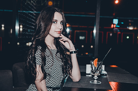 woman wearing black and white chevron tops near black wooden table thumbnail