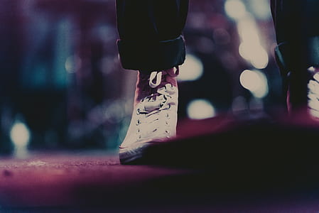 selective focus of person standing on gray pavement thumbnail