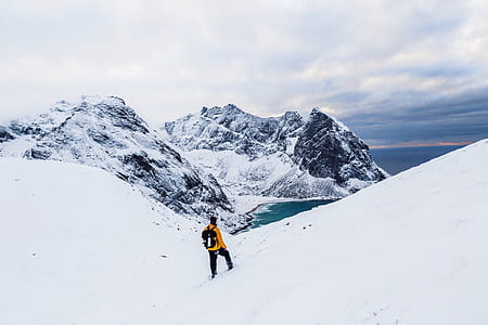 person climbing on mountain during winter thumbnail