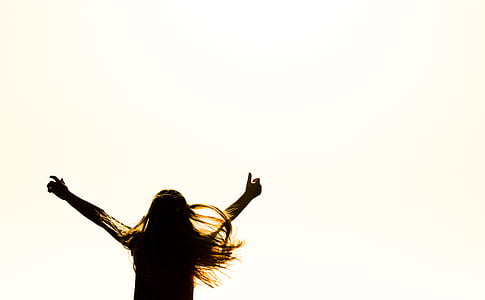Silhouette of Woman Raising Her Hands thumbnail