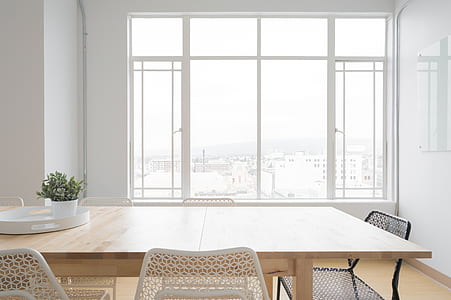 rectangular beige dining table across white window frame thumbnail