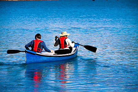 two people riding boat on blue calm body of water during daytime thumbnail