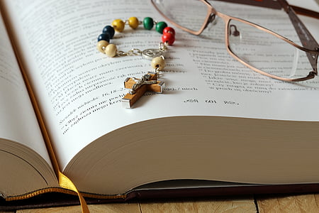 crucifix pendant bracelet on opened book thumbnail