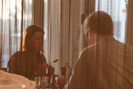 man in white dress shirt sitting on table in front of woman thumbnail