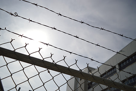 gray barbwire on top of cyclone fence thumbnail